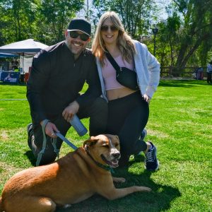 Bark in the Park image of a couple holding their dog on leash